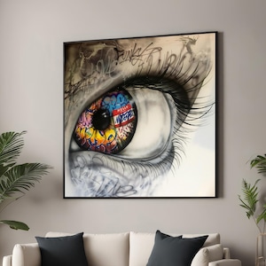 Puede incluir: Primer plano de un ojo colorido con letras de estilo graffiti y una etiqueta roja que dice "HELLO". El ojo está pintado en un estilo realista sobre un fondo blanco.