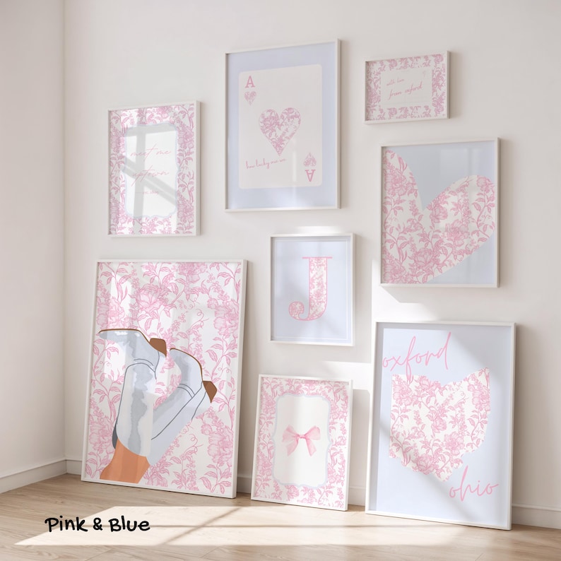 May include: A collection of framed art prints in white frames. The prints feature pink floral patterns, hearts, and text. One print shows a pair of light blue boots. The text "Pink & Blue" is at the bottom left.