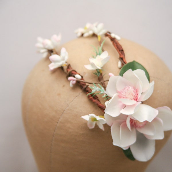 Flower Crown Double Arch with Pink and Ivory Magnolia flowers and green Leaves on a wooded base