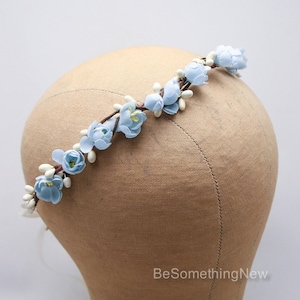flower crown from beautiful vintage flowers in a pretty shade of Baby Blue. I added them to some ivory pips on wire to create this special headband. It ties in the back with long narrow satin ribbons, and will bend to fit any size from a child to adult