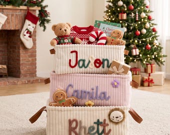 May include: Three stacked rectangular corduroy storage baskets with brown leather handles. The top basket features the name Jason, the middle basket says Camila, and the bottom basket displays the name Rhett, each in colorful embroidered lettering.