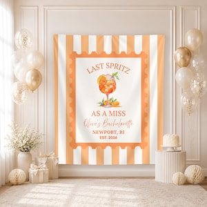 May include: A rectangular fabric backdrop featuring vertical orange and white stripes and a central stamp-shaped border. The design includes a watercolour illustration of an orange spritz cocktail with the text LAST SPRITZ AS A MISS, Olive's Bachelorette, NEWPORT, RI, EST. 2026.