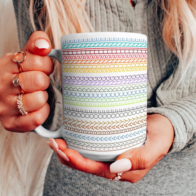 May include: A set of three ceramic mugs with a speckled, matte finish. The mugs are in shades of cream, light gray, and dark gray. Each mug has a simple, minimalist design and a rounded handle.