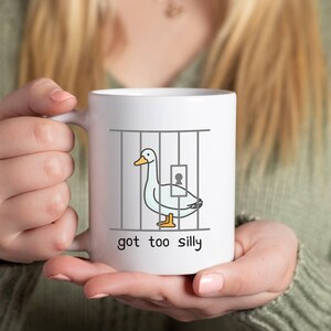 Person holding Got Too Silly Goose Mug