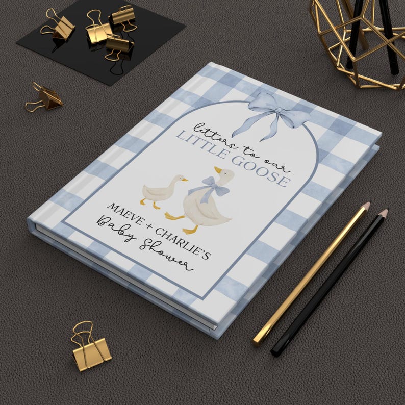 May include: A baby shower guest book with a blue and white gingham pattern. The cover features illustrations of geese and the text "Letters to our Little Goose" and "Maeve + Charlie's Baby Shower."