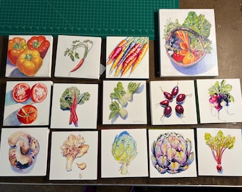 May include: A collection of 12 small paintings on canvas, each depicting a different type of vegetable. The vegetables include carrots, tomatoes, peppers, radishes, artichokes, mushrooms, and leafy greens.