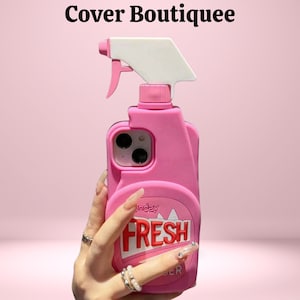 May include: Pink phone case shaped like a cleaning spray bottle, with a white spray nozzle and the word "FRESH" in red and white. The text "Cover Boutiquee" is at the top.