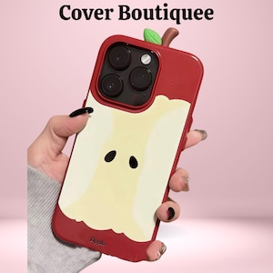 May include: Red phone case with an apple design. The case features a red exterior with a yellow and white apple slice design. The top has a green leaf and brown stem. The text "Cover Boutiquee" is at the top.