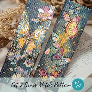 May include: A set of two cross stitch patterns featuring colorful butterflies on a dark blue background with a splatter paint effect. The patterns are titled "Set 2 Cross Stitch Pattern".