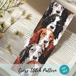 May include: Cross stitch pattern featuring three dogs stacked on top of each other. The dogs are a brown and white hound, a black and white dog, and a brown and white dog. The pattern is in a rectangular format and is labelled "Cross Stitch Pattern" and "PDF FILE".