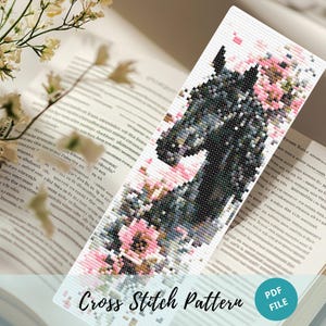 May include: A cross-stitch pattern bookmark featuring a black horse head with pink floral accents. The bookmark is set against an open book with the text "Cross Stitch Pattern" and a "PDF FILE" label.