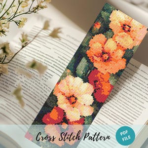 May include: Cross stitch pattern featuring a floral design with three large, white flowers with orange centers. The flowers are surrounded by green leaves and stems. The pattern is printed on a white background and includes the text "Cross Stitch Pattern" and "PDF FILE".