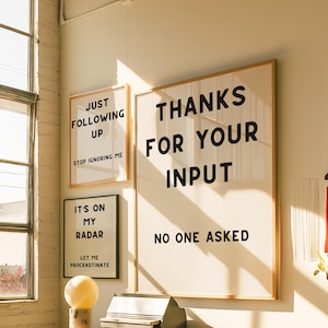 A set of four minimalist black-and-white digital art prints featuring sarcastic translations of common corporate phrases. Lets Touch Base I Need Something From You, Just Following Up Stop Ignoring Me, Its On My Radar Let Me Procrastinate, and Thanks For Your Input No One Asked. Perfect for office decor, work-from-home spaces, or as a gift for coworkers who appreciate workplace humor.