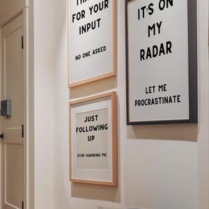 A set of four minimalist black-and-white digital art prints featuring sarcastic translations of common corporate phrases. Lets Touch Base I Need Something From You, Just Following Up Stop Ignoring Me, Its On My Radar Let Me Procrastinate, and Thanks For Your Input No One Asked. Perfect for office decor, work-from-home spaces, or as a gift for coworkers who appreciate workplace humor.