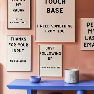 A set of four minimalist black-and-white digital art prints featuring sarcastic translations of common corporate phrases. Lets Touch Base I Need Something From You, Just Following Up Stop Ignoring Me, Its On My Radar Let Me Procrastinate, and Thanks For Your Input No One Asked. Perfect for office decor, work-from-home spaces, or as a gift for coworkers who appreciate workplace humor.