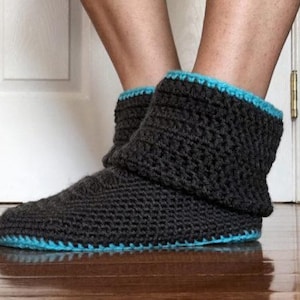 May include: Gray crocheted slipper boots with a blue trim. The boots are made with a soft, cozy yarn and are perfect for keeping your feet warm in the winter.
