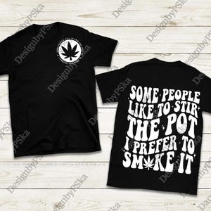 May include: Black t-shirts with white text and a cannabis leaf design. One shirt has a small leaf and text that reads "SOME PEOPLE LIKE TO STIR THE POT I PREFER TO SMOKE IT." The other shirt has the same text on the back.