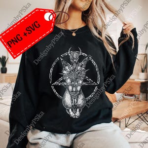 May include: Black sweatshirt featuring a detailed white graphic of a figure within a pentagram. The design includes intricate line work and a gothic aesthetic. The tag in the upper left corner reads "PNG + SVG".