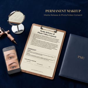 May include: An image featuring tools and documents related to permanent makeup. A clipboard with a media release form, a smartphone displaying before-and-after eyebrow images, a small mirror, a tattoo machine, and a navy blue notebook with "PMU" embossed on it.