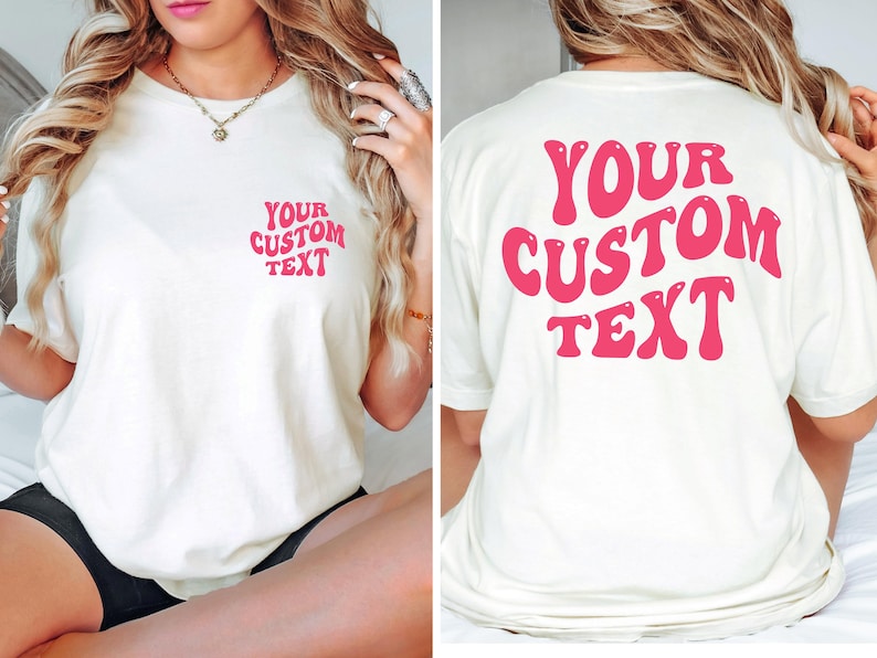 May include: White t-shirt with pink retro font that says "YOUR CUSTOM TEXT" on the front and back.