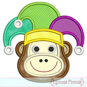 May include: A whimsical monkey face design with a jester hat in shades of green, purple, and yellow. The monkey has a smiling red mouth, black eyes, and brown ears. The design is likely for embroidery or applique.
