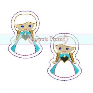 May include: Two embroidered images of a girl with blonde hair wearing a blue and white dress with a black heart on the front. The girl has blue eyes and a smile.