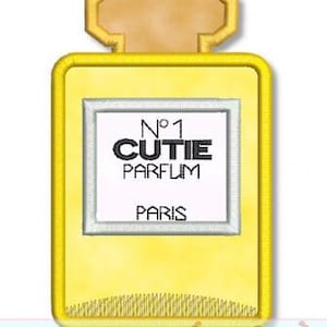 May include: A yellow perfume bottle with a gold top and a white label that says "No. 1 CUTIE PARFUM PARIS".