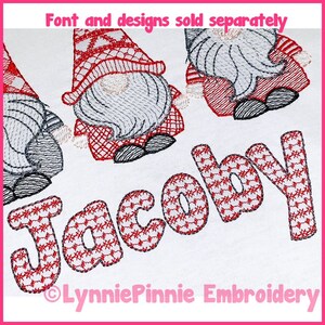 May include: Embroidered design of the name "Jacoby" in red and white with a checkered pattern. Two gnomes are embroidered on either side of the name. The gnomes are wearing red and white hats and have gray beards. The text "Font and designs sold separately" is at the top of the image. The text "LynniePinnie Embroidery" is at the bottom of the image.