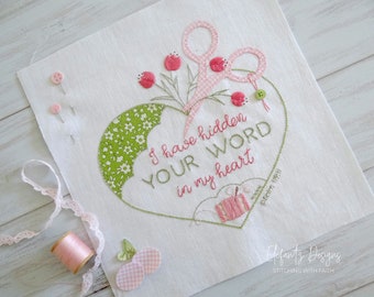 May include: Embroidered heart-shaped design with green and white fabric, pink scissors, and pink flowers. The text "I have hidden YOUR WORD in my heart Psalm 119:11" is stitched in pink thread. The design is on a white fabric background.