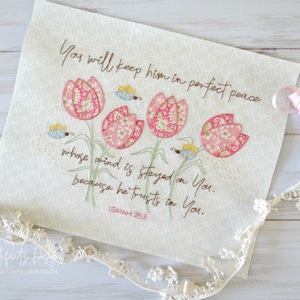 May include: Embroidered artwork featuring a floral design with pink tulips and butterflies. The artwork includes the text "You will keep him in perfect peace whose mind is stayed on You. because he trusts in You. ISAIAH 26:3"
