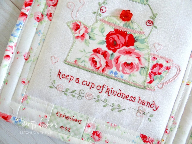 May include: White fabric with a red and green embroidered teapot and cup with the text "keep a cup of kindness handy" and "Ephesians 4:32".
