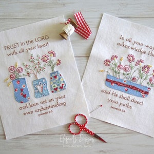 May include: Two embroidered fabric panels featuring floral designs and bible verses. The first panel reads "TRUST in the LORD with all your heart and lean not on your own understanding Proverbs 3:5". The second panel reads "In all your ways acknowledge Him and He shall direct your paths Proverbs 3:6".
