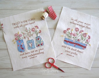 Puede incluir: Dos paneles de tela bordados con diseños florales y versículos bíblicos. El primer panel dice "TRUST in the LORD with all your heart and lean not on your own understanding Proverbs 3:5". El segundo panel dice "In all your ways acknowledge Him and He shall direct your paths Proverbs 3:6".