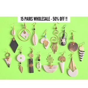 May include: A collection of fifteen pairs of earrings with various designs, including geometric shapes, leaf, and spiral patterns. The earrings feature gold-tone metal, wood, and shell accents, set against a bright green background.