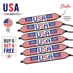 May include: Six beaded bracelets featuring the USA flag design with red, white, and blue beads. Each bracelet displays the text USA in blue and red beads, with a blue square containing white dots and horizontal red and white stripes. Black elastic cords.