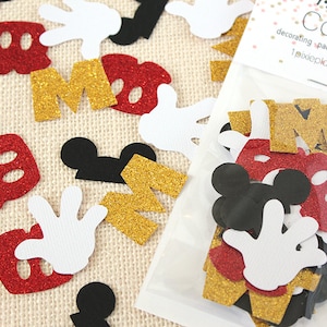 May include: A bag of confetti featuring Mickey Mouse themed shapes, including red and gold glitter letters, black Mickey Mouse ears, and white Mickey Mouse gloves. The bag is labelled "Pixie Place Confetti - decorating, packaging, gift wrapping pixieplace.etsy.com"