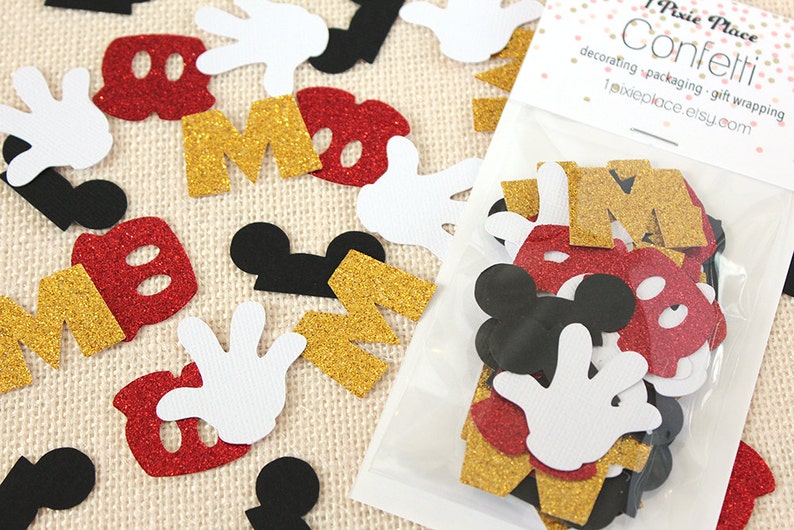May include: A bag of confetti featuring Mickey Mouse themed shapes, including red and gold glitter letters, black Mickey Mouse ears, and white Mickey Mouse gloves. The bag is labelled "Pixie Place Confetti - decorating, packaging, gift wrapping pixieplace.etsy.com"