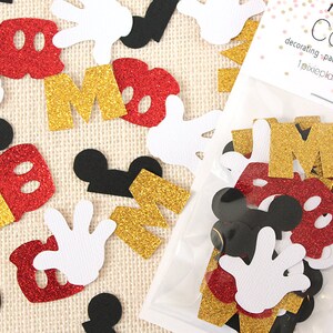 May include: A bag of confetti featuring Mickey Mouse themed shapes in red, gold, black, and white. The confetti includes Mickey Mouse ears, hands, and the letter "M". The bag has a label that reads "1 Pixie Place Confetti decorating - packaging - gift wrapping 1pixieplace.etsy.com"