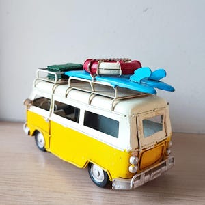 Retro van miniature, van replica in royal blue and white with surfboards and life saver on baggage rack
