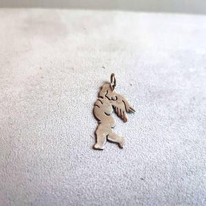 Silver angel pendant, sterling silver pendant of chubby angel child in profile with silver hoop on top