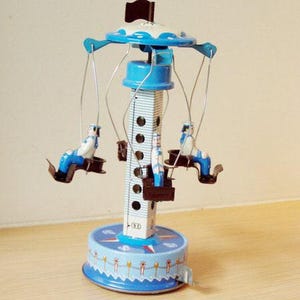 Vintage metal carousel, blue and white carnival ride with sailors, retro collectible toy, winiding blue white carousel toy, baby shower gift