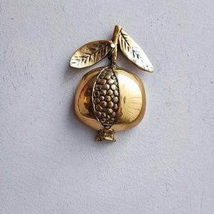 Brass pomegranate sculpture, vintage pomegranate figure, half a pomegranate with two leaves and seeds showing, greek folk art