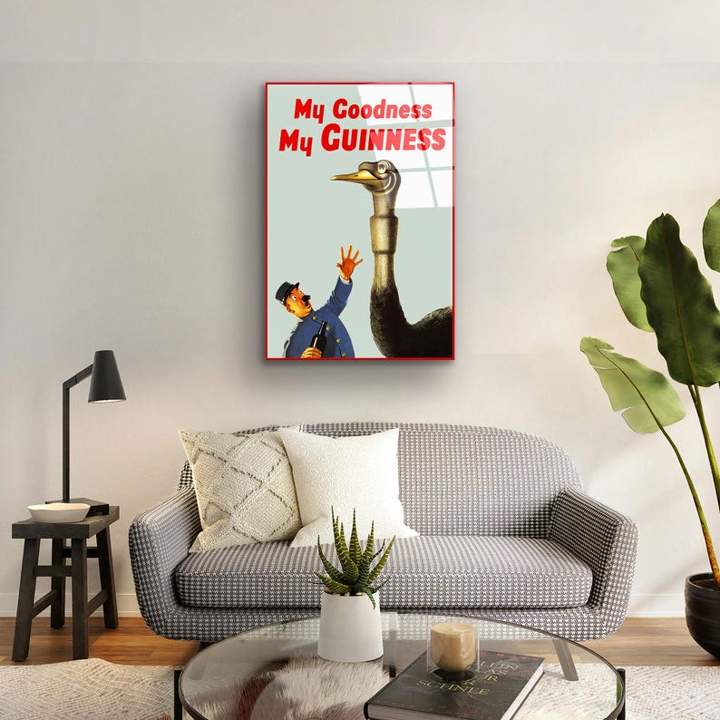 May include: A vintage Guinness advertisement featuring a man in a blue uniform reaching out to a large ostrich with the text "My Goodness My GUINNESS".