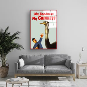 May include: A vintage poster advertising Guinness beer. The poster features a cartoon illustration of a man reaching out to an ostrich with the text "My Goodness My GUINNESS" in red.
