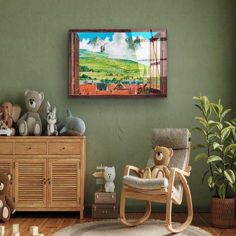May include: A framed print of a window view with a colorful landscape scene. The window is open and the view shows a green field, a small town, and mountains in the distance. The print is hanging on a green wall above a wooden dresser.