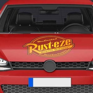 May include: A red car with the "Rust-eze" logo on the hood. The car has a black grill and headlights. The car's license plate is white. The car is a hatchback.
