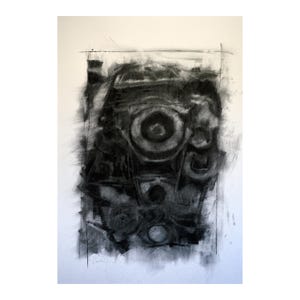 May include: Abstract charcoal drawing on white paper. The artwork features a central circular form with concentric rings, surrounded by other shapes and textures. The piece is predominantly black and grey.