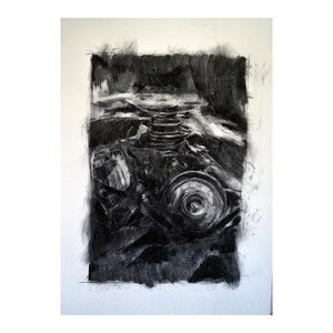 May include: A black and white charcoal drawing of a mechanical object with a circular shape in the centre.