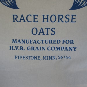 May include: A white fabric bag with blue text that reads "Race Horse Oats Manufactured for H.V.R. Grain Company Pipestone, Minn., 56164".