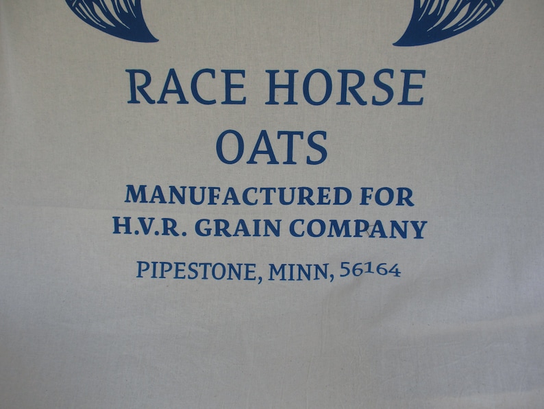 May include: A white fabric bag with blue text that reads "Race Horse Oats Manufactured for H.V.R. Grain Company Pipestone, Minn., 56164".